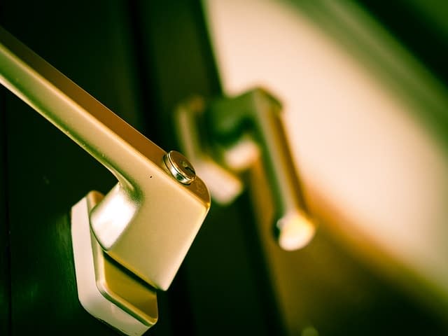 Close up of a window with brass handles